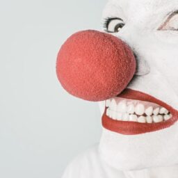 Smiling clown with red ball on nose