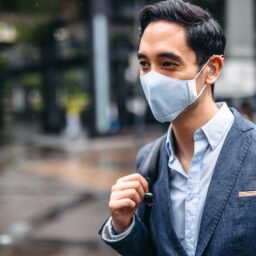 Business man wearing a mask outdoors.