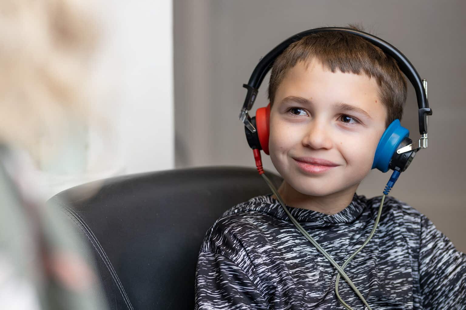 Child wearing headphones while receiving a hearing test