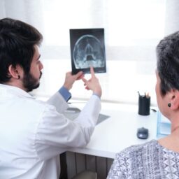 Doctor showing xray of sinuses to a patient