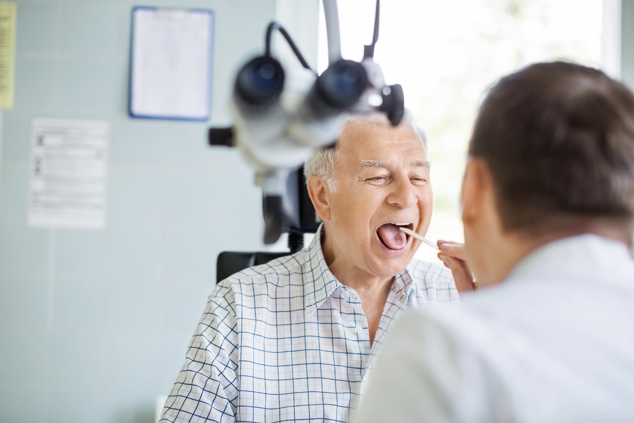 Man in a throat exam.